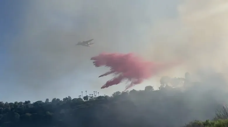 An aircraft drops retardant over Clairemont Mesa West as crews battle a brush fire. (Photo courtesy of San Diego Fire-Rescue Department)